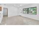 Bright living room with a ceiling fan, neutral walls, and terrazzo flooring at 2003 E Clinton St, Tampa, FL 33610
