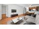Open living space with dining area, wood floors, and gray decor featuring an entertainment center at 209 Woodlake Wynde, Oldsmar, FL 34677