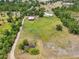 Stunning aerial view of acreage with home and barn at 21019 Lonesome Acre Rd, Wimauma, FL 33598