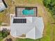 Aerial view of backyard featuring a kidney-shaped pool, hot tub, and solar panels at 21019 Lonesome Acre Rd, Wimauma, FL 33598