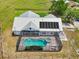 Aerial view showcases the home's roof-mounted solar panels and fenced-in pool area at 21019 Lonesome Acre Rd, Wimauma, FL 33598