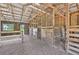 Interior view of the barn with stalls and overhead trusses at 21019 Lonesome Acre Rd, Wimauma, FL 33598