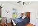 Bright bedroom includes hardwood floors and lots of natural light, overlooking a fenced in field at 21019 Lonesome Acre Rd, Wimauma, FL 33598
