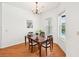 Bright dining room features wood floors, a chandelier, large windows, and a view of the pool at 21019 Lonesome Acre Rd, Wimauma, FL 33598