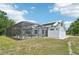 Exterior view of home and screened-in pool with a brick-paver patio, yard and solar panels on the roof at 21019 Lonesome Acre Rd, Wimauma, FL 33598