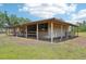 Image of horse barn with horse at a gated entrance to the barn at 21019 Lonesome Acre Rd, Wimauma, FL 33598
