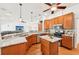 Modern kitchen featuring granite countertops, stainless steel appliances, island, and wood cabinets at 21019 Lonesome Acre Rd, Wimauma, FL 33598
