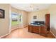 Spacious home office with large desk, bay window, and serene views of the outdoors at 21019 Lonesome Acre Rd, Wimauma, FL 33598