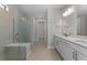 Bathroom featuring double vanity, walk-in shower, and tile flooring at 2541 Charter Oak Dr, North Port, FL 34289