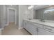 Bright bathroom features a double vanity with modern fixtures and a walk-in shower at 2541 Charter Oak Dr, North Port, FL 34289