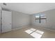 Sunny bedroom with neutral walls, tile flooring, and a large window at 2541 Charter Oak Dr, North Port, FL 34289