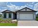 Charming single-Gathering home with a two-car garage, manicured lawn, and beautiful curb appeal at 2541 Charter Oak Dr, North Port, FL 34289