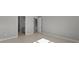 Neutral hallway featuring tile flooring and doors to rooms throughout the home at 2541 Charter Oak Dr, North Port, FL 34289