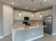 Modern kitchen with stainless steel appliances, a center island, pendant lighting and ample cabinet space at 2541 Charter Oak Dr, North Port, FL 34289