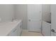 Clean laundry room with washer, white cabinets, countertop, and sink at 2541 Charter Oak Dr, North Port, FL 34289