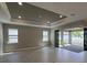 Spacious living room with tray ceilings, recessed lighting, and sliding doors to a covered lanai at 2541 Charter Oak Dr, North Port, FL 34289
