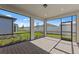 The screened patio features tiled flooring with views of the backyard and fence at 2541 Charter Oak Dr, North Port, FL 34289
