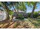 Back of house showing wood deck and back yard surrounded by mature trees at 2810 N Jefferson St, Tampa, FL 33602