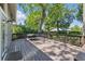 Wooden backyard deck with outdoor table and chairs shaded by mature trees at 2810 N Jefferson St, Tampa, FL 33602