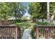Backyard with grass and mature trees, viewed from wooden steps at 2810 N Jefferson St, Tampa, FL 33602