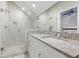 Modern bathroom with double sink vanity and walk-in shower with marble tile at 2810 N Jefferson St, Tampa, FL 33602