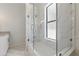 Bright bathroom features a shower over tub with glass enclosure and marble tile at 2810 N Jefferson St, Tampa, FL 33602