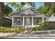 Charming home with a welcoming front porch and inviting curb appeal surrounded by lush greenery at 2810 N Jefferson St, Tampa, FL 33602