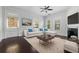 Bright living room with a decorative fireplace, ceiling fan, plush sofa, and natural light at 2810 N Jefferson St, Tampa, FL 33602