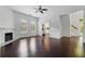 Open-concept living area with access to kitchen and staircase, hardwood floors, and a decorative fireplace at 2810 N Jefferson St, Tampa, FL 33602