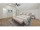 Main bedroom features a neutral decor, ceiling fan, and ensuite bathroom at 2810 N Jefferson St, Tampa, FL 33602