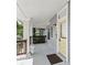 Inviting porch with classic columns and a sunny yellow door, perfect for relaxing and enjoying the outdoors at 2810 N Jefferson St, Tampa, FL 33602