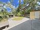 A concrete patio and mature trees accent this home's well-maintained backyard at 315 Wooten Rd, Lutz, FL 33548