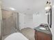Bathroom featuring double sinks, granite countertops, shower and tiled floors at 315 Wooten Rd, Lutz, FL 33548