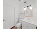 This bathroom features a toilet, sink with vanity and a decorative mirror at 315 Wooten Rd, Lutz, FL 33548