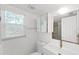 Bathroom featuring a new vanity, mirror, sink, and toilet at 315 Wooten Rd, Lutz, FL 33548