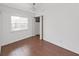 Bedroom featuring wood floors, natural light from the window, and a closet for storage at 315 Wooten Rd, Lutz, FL 33548