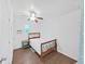 Bright bedroom features wood floors, a ceiling fan, and a wooden bed frame at 315 Wooten Rd, Lutz, FL 33548