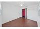 Cozy bedroom with hardwood floors, ceiling fan, and closet for ample storage at 315 Wooten Rd, Lutz, FL 33548