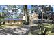 Spacious two-story home with a carport and lush landscaping at 315 Wooten Rd, Lutz, FL 33548