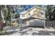 Charming two-story home with a carport and a well-manicured front yard at 315 Wooten Rd, Lutz, FL 33548