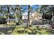Charming two-story home with lush landscaping, screened porch, and carport at 315 Wooten Rd, Lutz, FL 33548