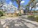 Charming two-story home with an expansive gravel driveway and covered carport at 315 Wooten Rd, Lutz, FL 33548