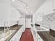 Bright kitchen with white cabinets, dark countertops, stainless steel appliances, and wood floors at 315 Wooten Rd, Lutz, FL 33548