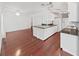 Open concept kitchen featuring granite countertops, stainless appliances, and wood floors at 315 Wooten Rd, Lutz, FL 33548