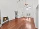 Spacious living room with wood floors, a fireplace, soaring ceilings, and plentiful natural light at 315 Wooten Rd, Lutz, FL 33548
