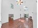 Open concept living room featuring hardwood floors, tall ceilings, fireplace, and natural light at 315 Wooten Rd, Lutz, FL 33548