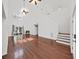 Bright living room featuring wood floors, a fireplace, large windows, and a staircase at 315 Wooten Rd, Lutz, FL 33548