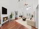 Bright living room features vaulted ceilings, wood floors, fireplace, and stylish neutral furniture at 315 Wooten Rd, Lutz, FL 33548