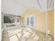 Screened sunroom featuring stone flooring and a decorative glass door leading to the interior of the home at 315 Wooten Rd, Lutz, FL 33548