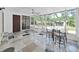 Bright sunroom boasts natural light, a ceiling fan, and a stone tile floor at 315 Wooten Rd, Lutz, FL 33548